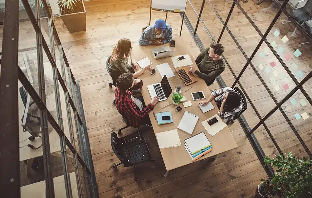 Business employees sitting around a table working