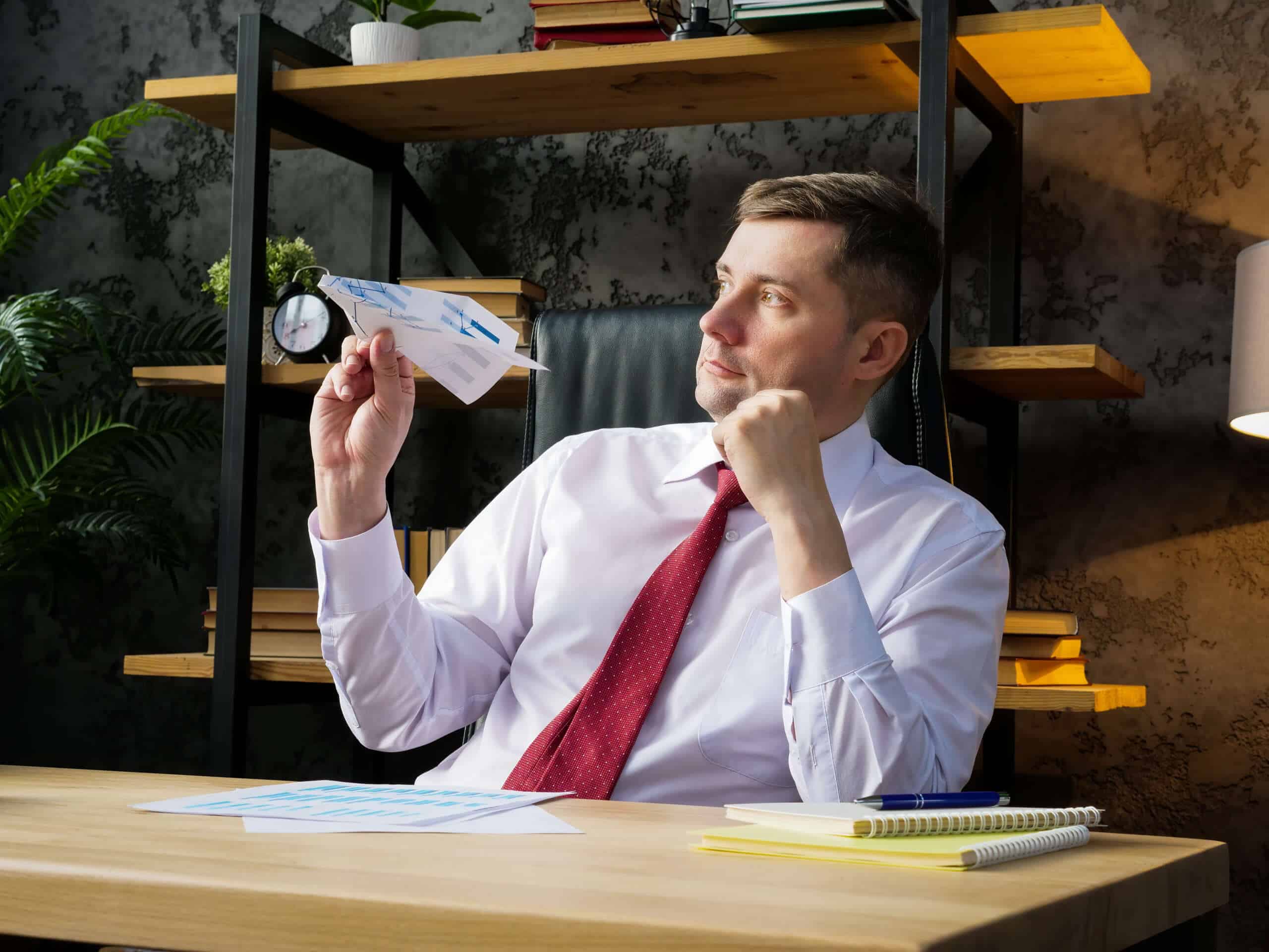 Disengaged Employee creates a paper airplane