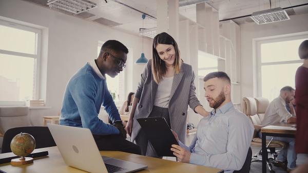 Coworkers gathered around computer