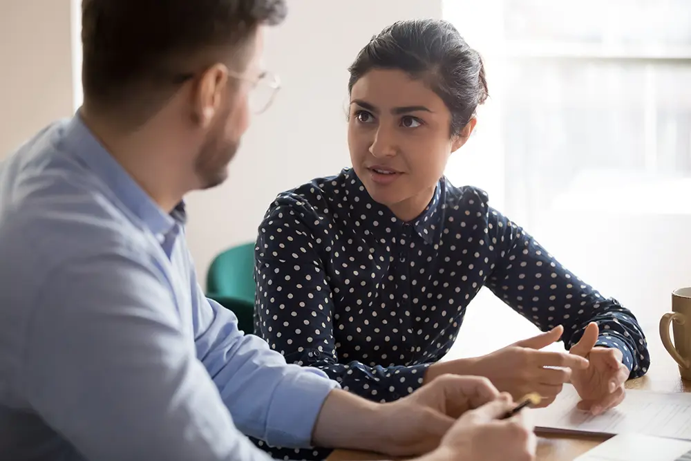 man and women at table having discussion