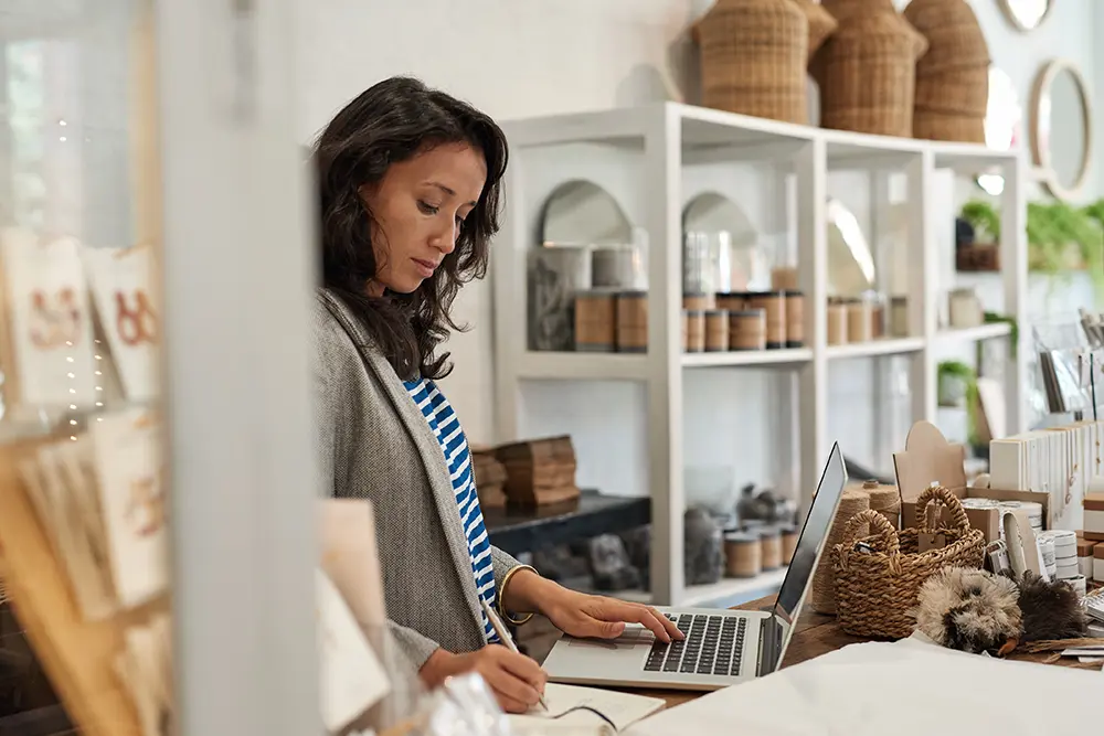 Woman on computer at pottery shop