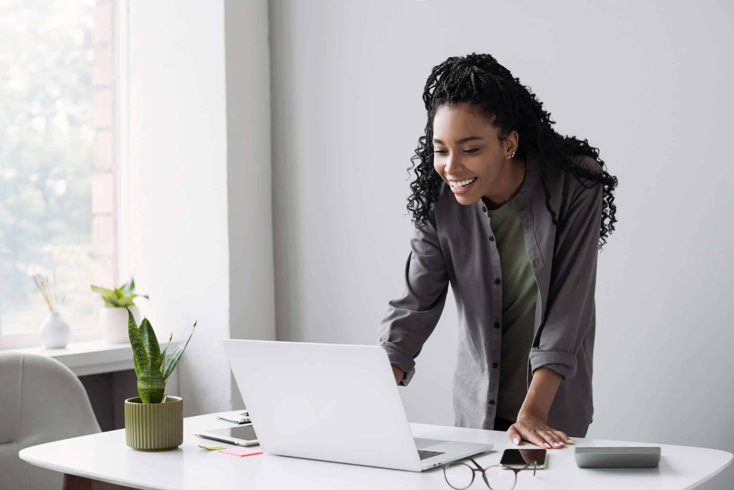 Young woman using laptop computer at office. Student girl workin