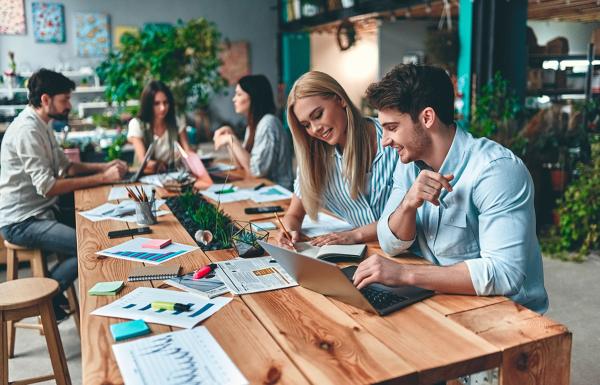 Employee team meeting together to discuss survey results