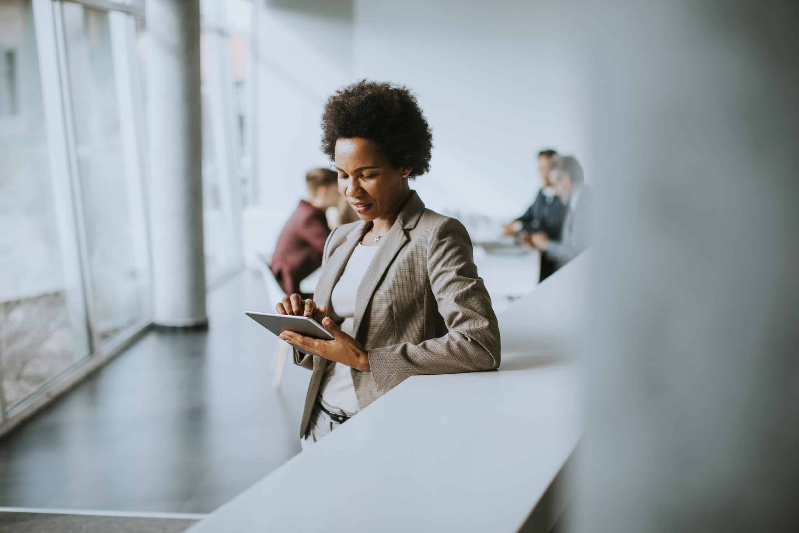 Businesswoman standing and using digital tablet