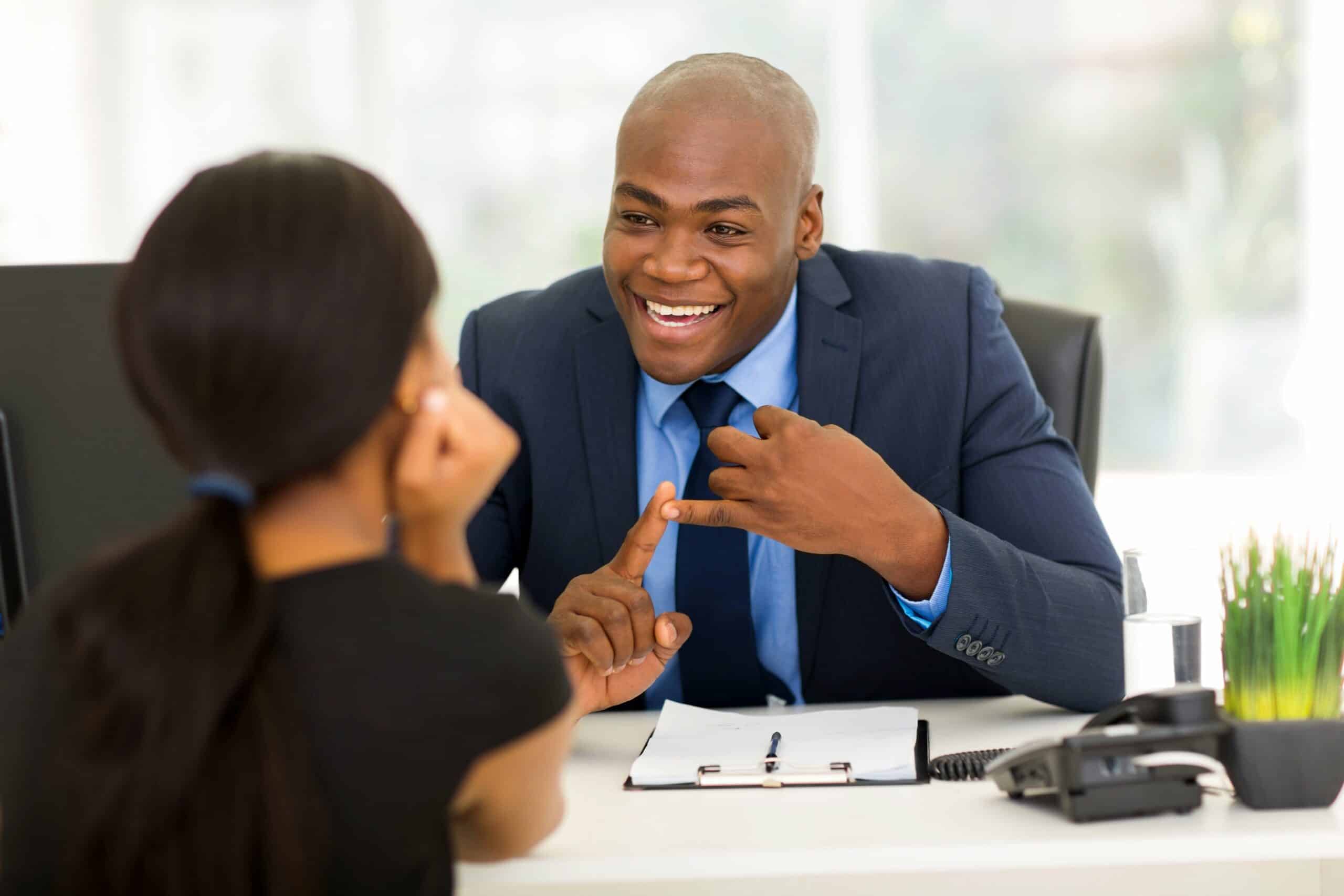 Man and woman talking at a desk