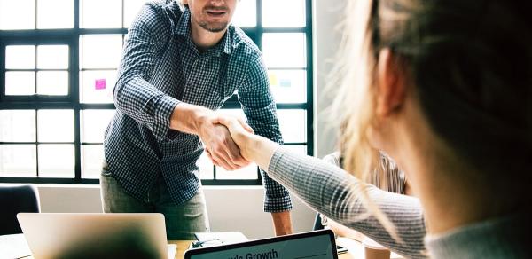 two coworkers shaking hands