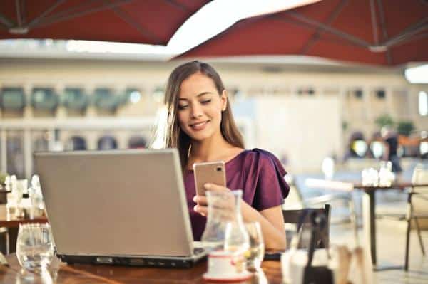 woman at restaurant looking at phone