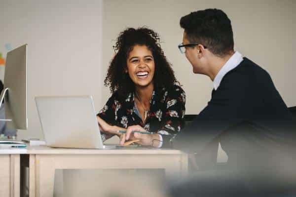 Business man and woman sitting at their computers