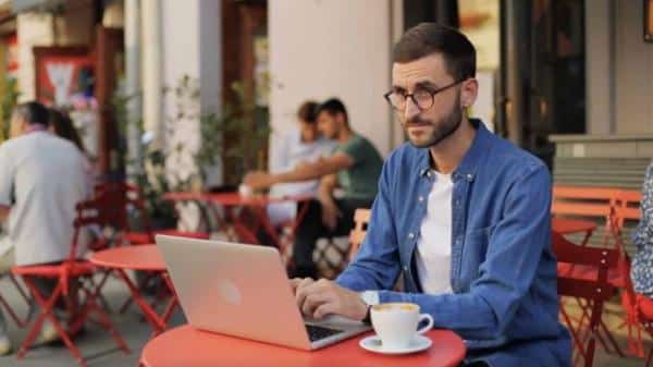 Young man works on employee survey on computer