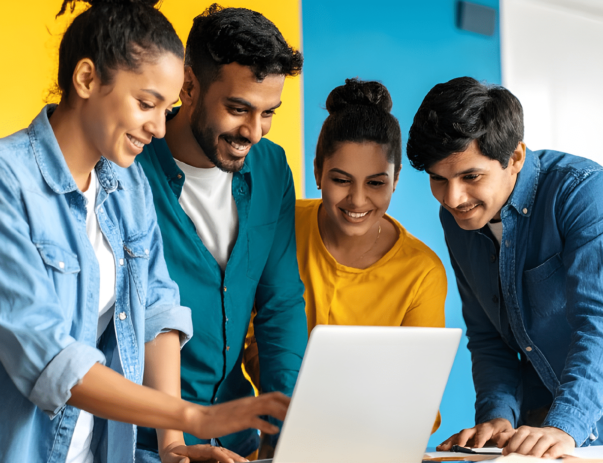 4 people gathered around a laptop