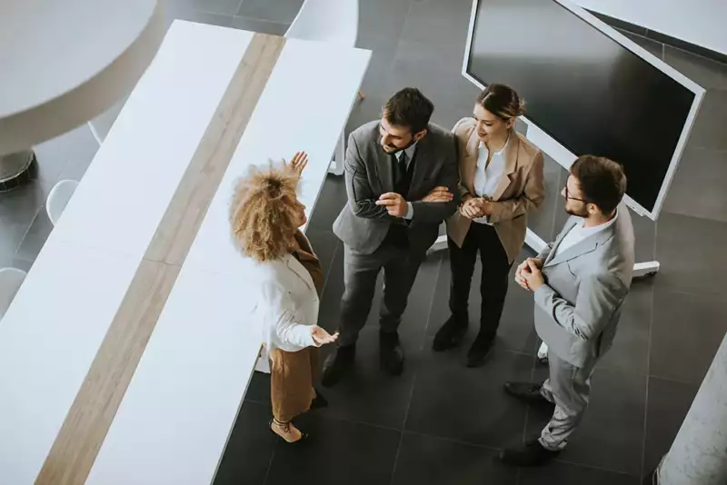 employees reviewing performance together around a chalkboard