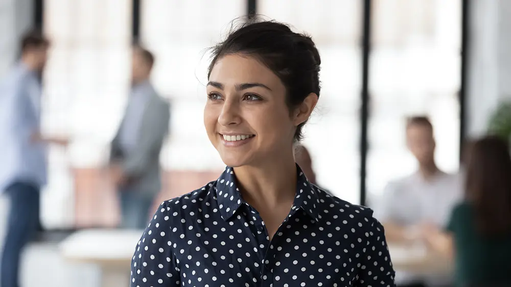 Portrait of happy confident Indian businesswoman smiling, looking away