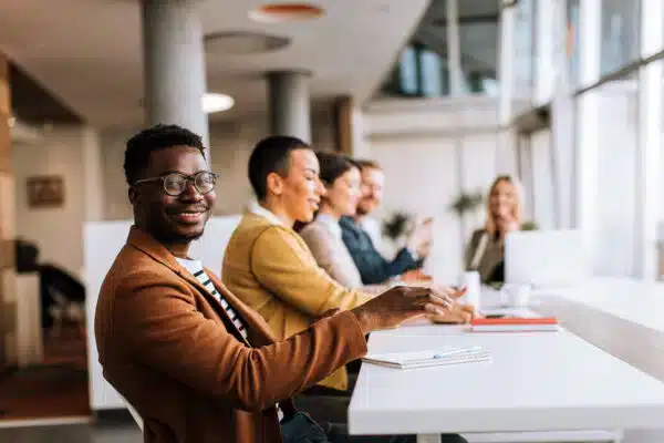 Satisfied employees sit together at table