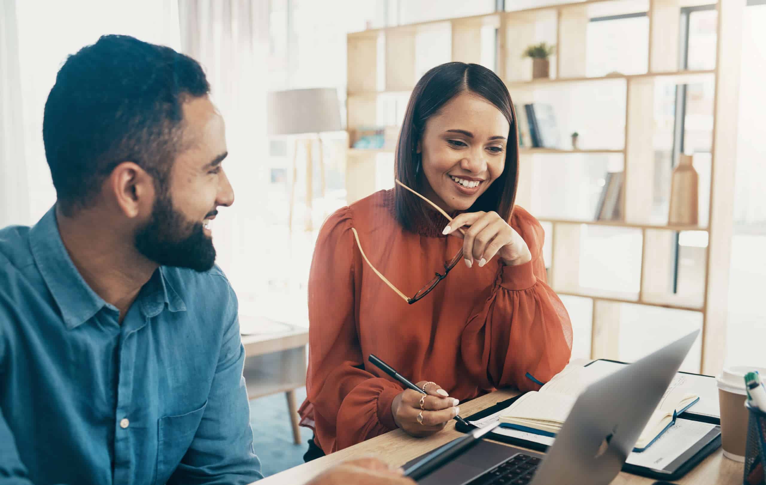 Employee, manager and office with laptop for feedback, project review and designer for discussion. Man, woman and consulting with technology, performance and happiness with career progress.