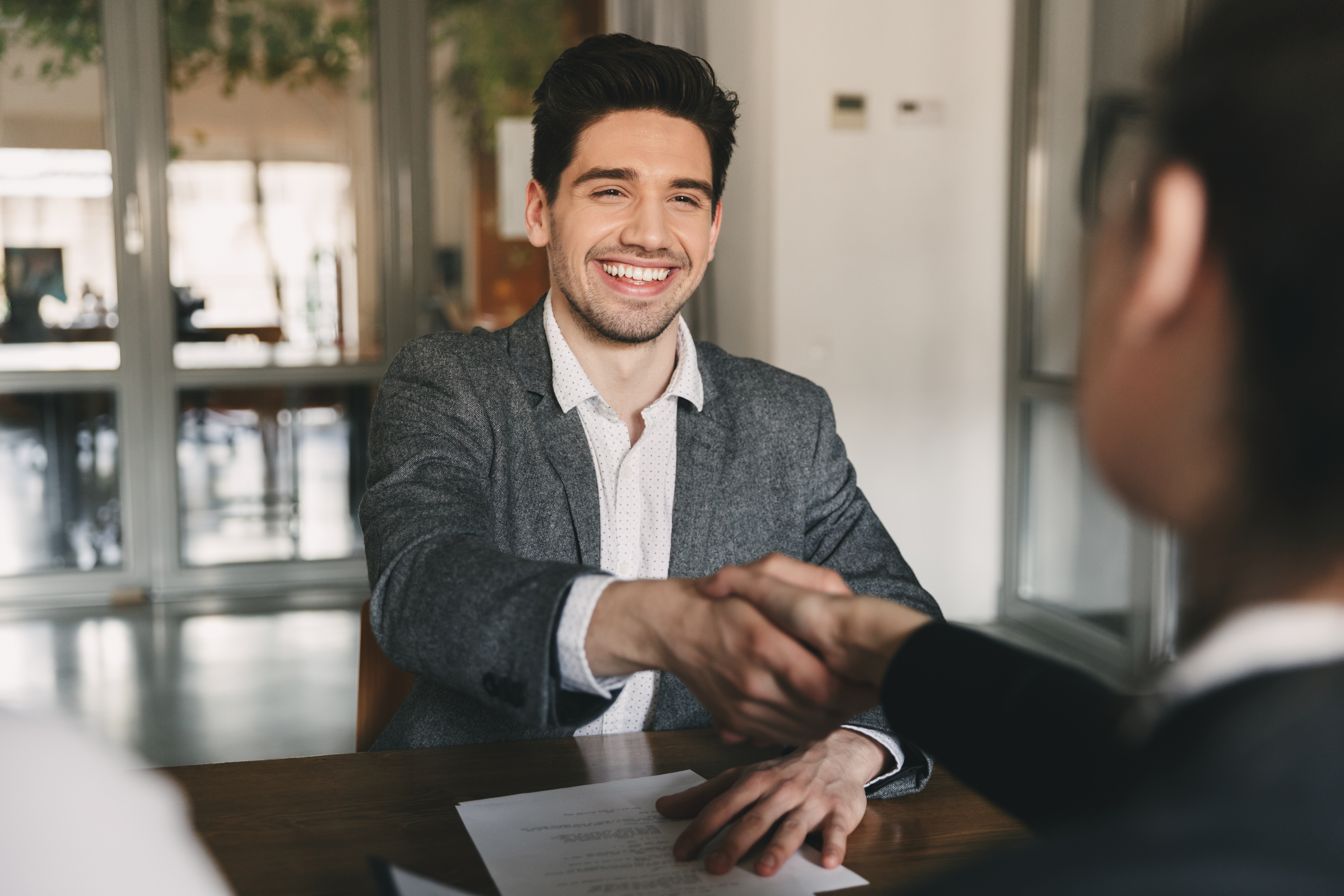 Employee shaking hands after exit survey and interview