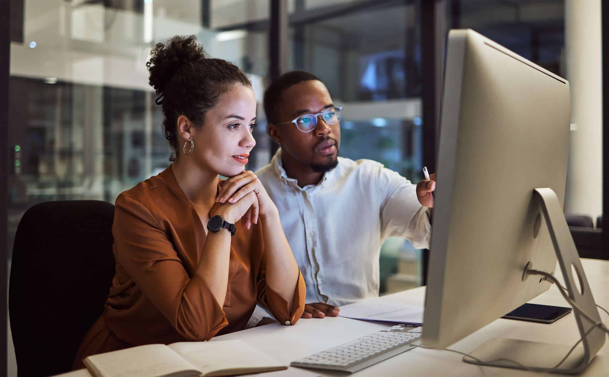 employees comparing alternatives on computer