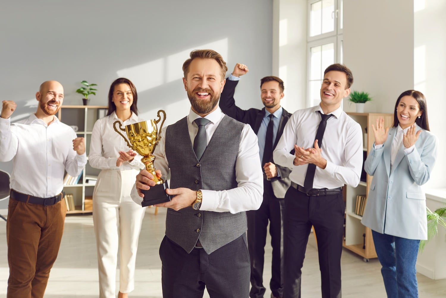 employee holding trophy