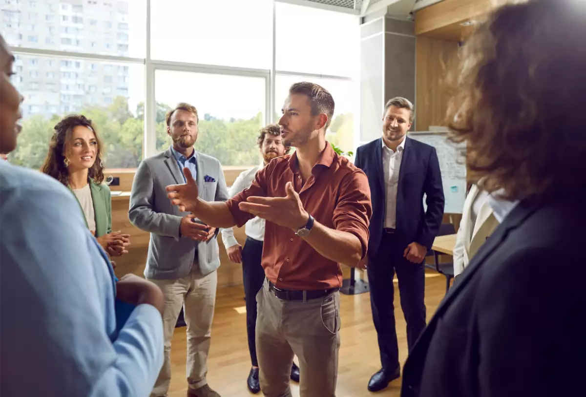 Business Coach Standing in Circle Coaching a group