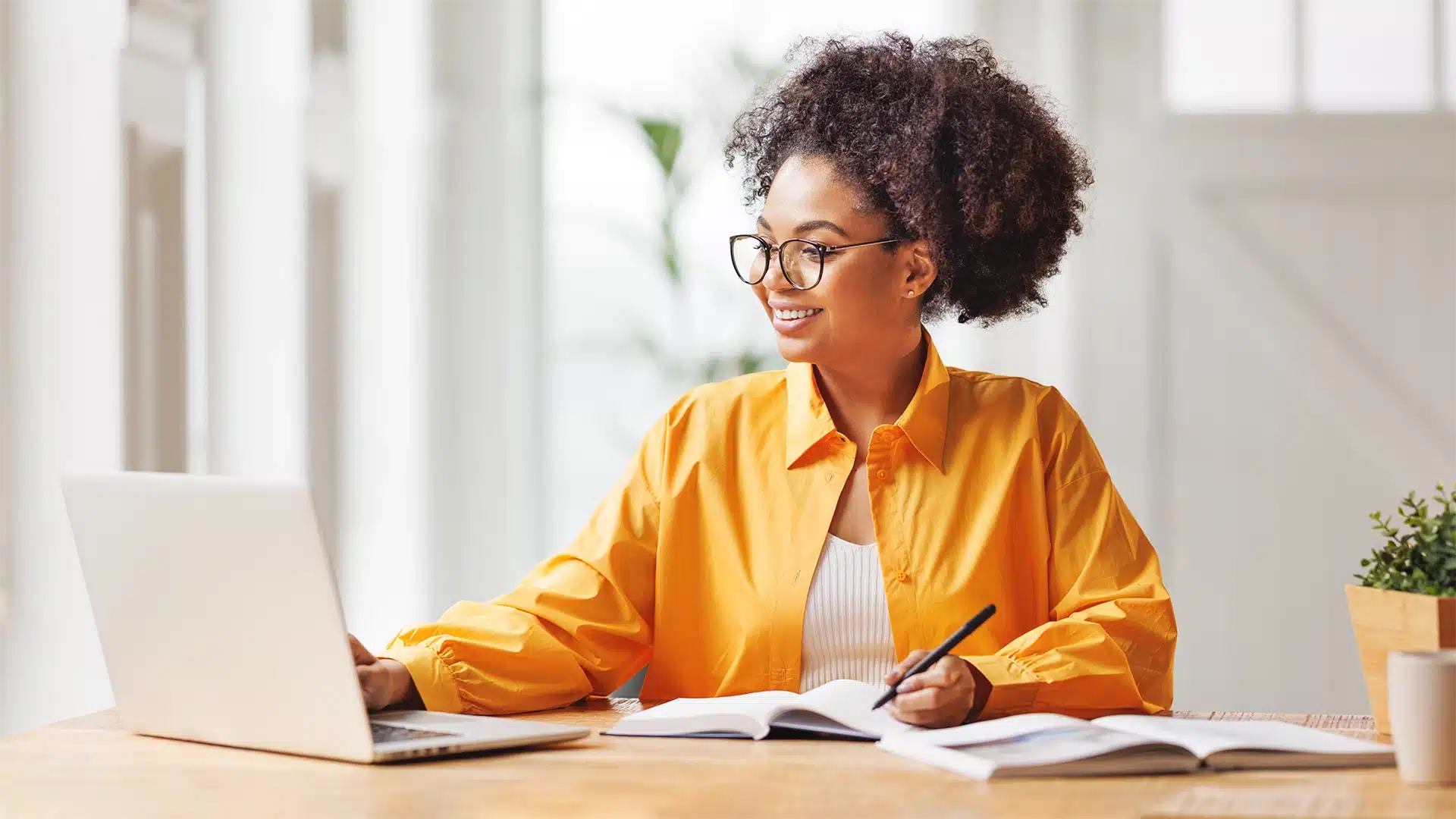 business woman taking notes and working at laptop business woman taking notes and working at laptop